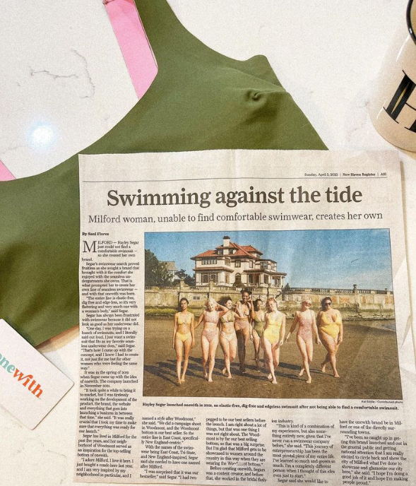 New Haven Register page headlined Swimming against the tide, swimsuit team photo with green onewith suit nearby