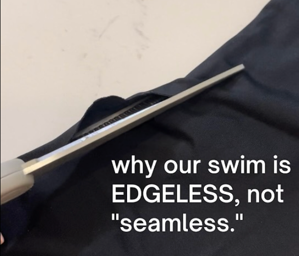 Scissors cutting swimsuit fabric with text: why our swim is EDGELESS, not 'seamless'.