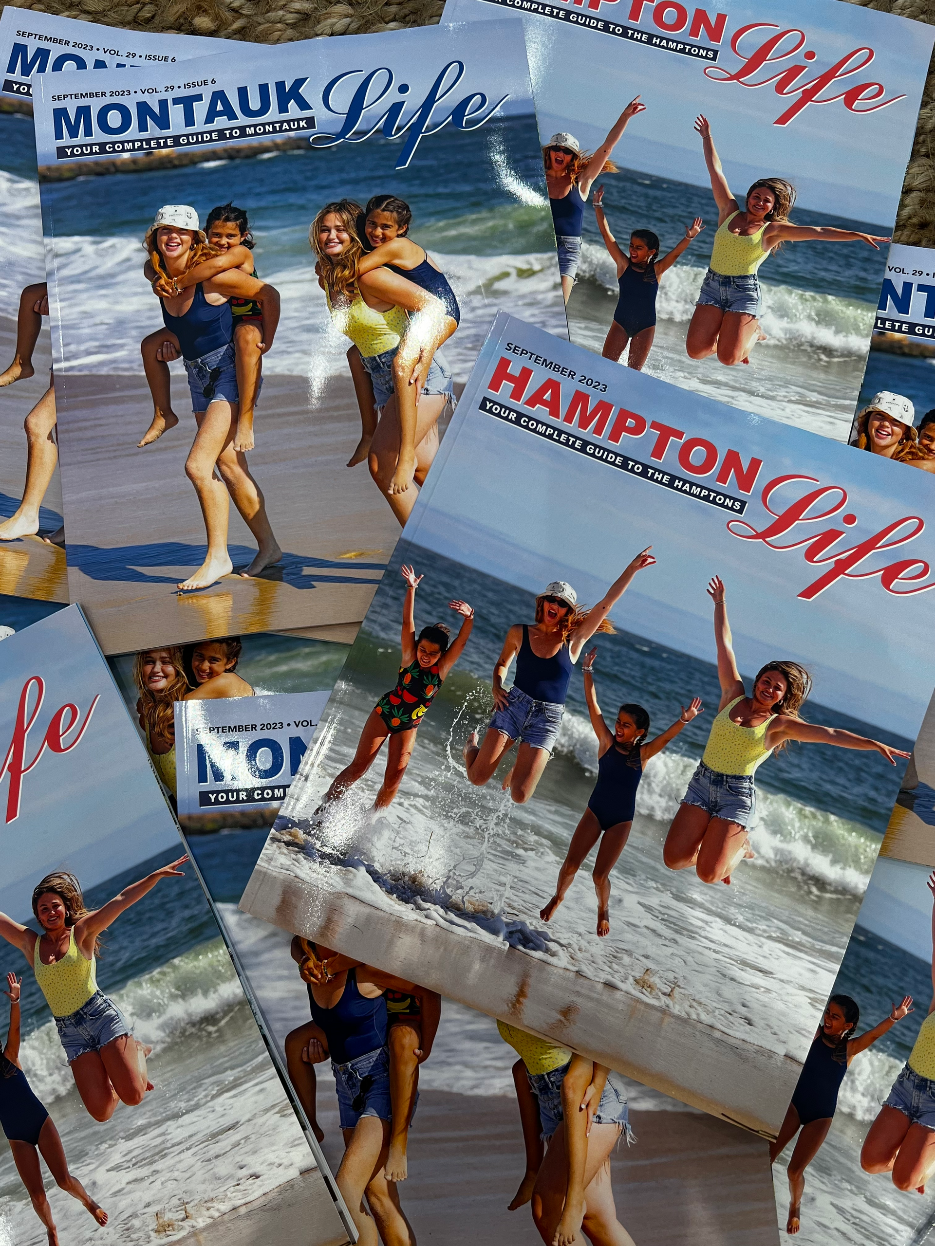Stacked 'Montauk Life' and 'Hampton Life' magazine covers showing four women and girls jumping on a sunny beach