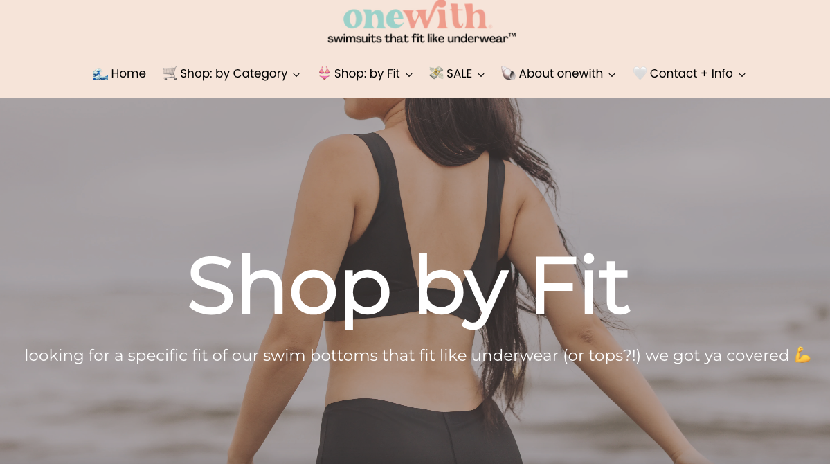 Woman shown from back in black seamless swim top and bottoms on the beach; hero banner text 'Shop by Fit' visible.