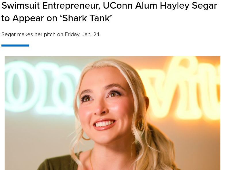 Hayley Segar, swimsuit entrepreneur and UConn alum, smiling in a headshot with neon sign background.