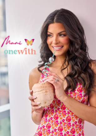 Smiling woman in a pink floral dress holding a pink smoothie cup; text 'Share one with' on the left.