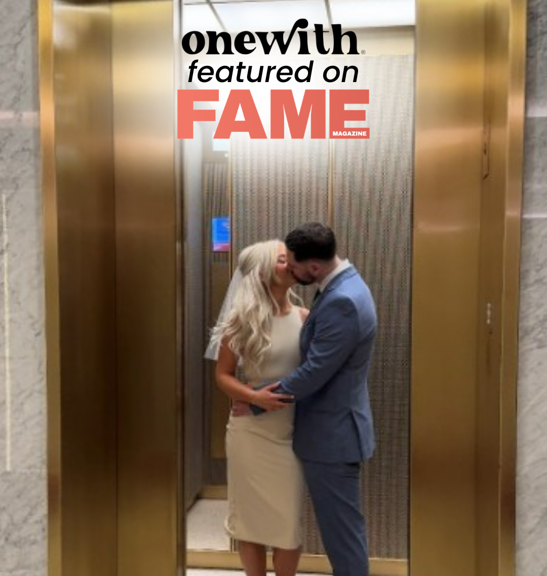 onewith featured on FAME, woman in fitted ivory swimsuit-style wedding dress kissing partner inside a gold elevator