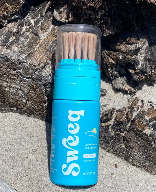 Blue sand remover with bristles on a rocky surface
