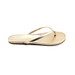 Metallic gold thong sandal with thin straps and low sole on white background