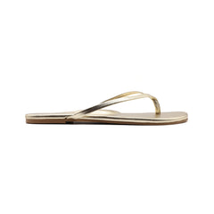 Metallic gold thong sandal on white background, side view.