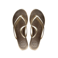 Top-view of a pair of brown flip-flops with circular logos on the heels