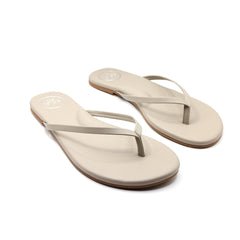 Beige foam flip-flop sandals, pair with thong straps photographed at a slight angle