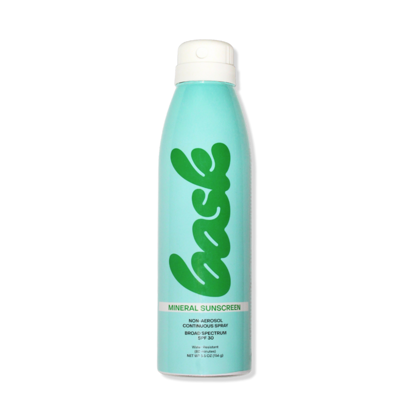 Bask mineral sunscreen aerosol can, turquoise bottle with green 'bask' logo and 'MINERAL SUNSCREEN' text.