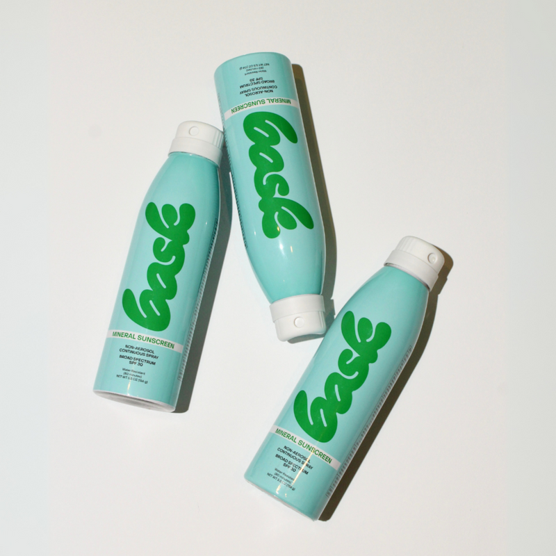 Three Bask mineral sunscreen aerosol cans