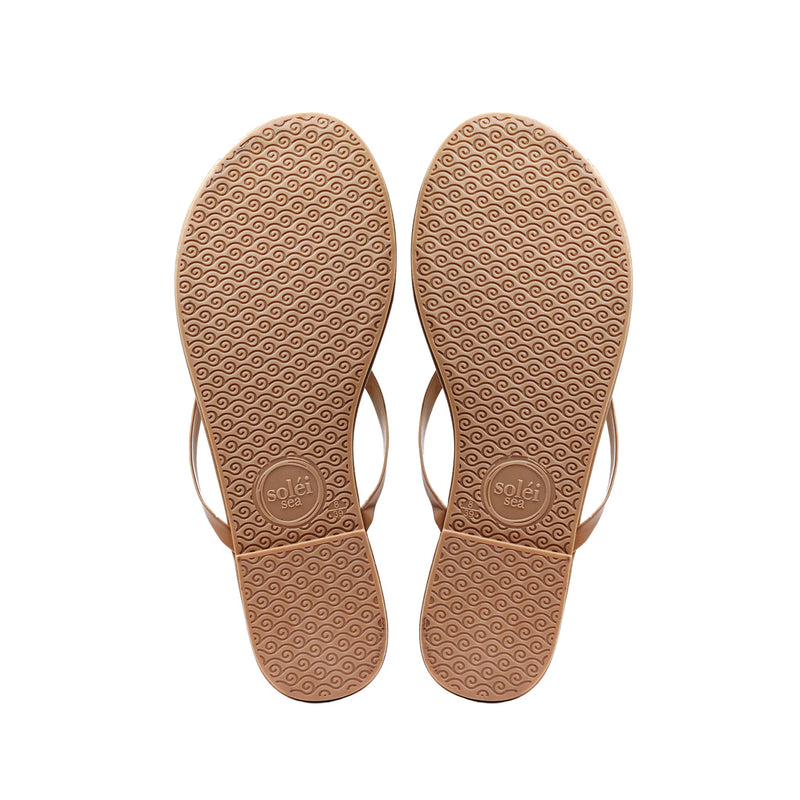 Pair of tan leather sandals with ankle straps, top view