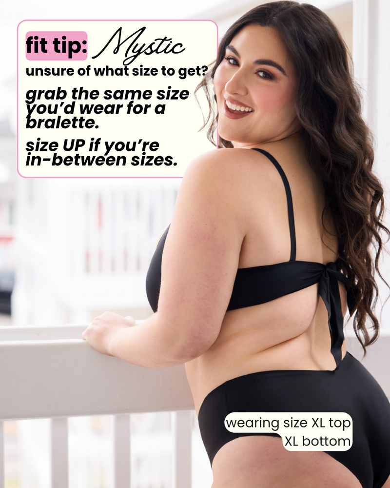 Woman wearing a black bikini with text on sizing advice.